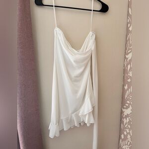 White mini dress with ruffle detail.
